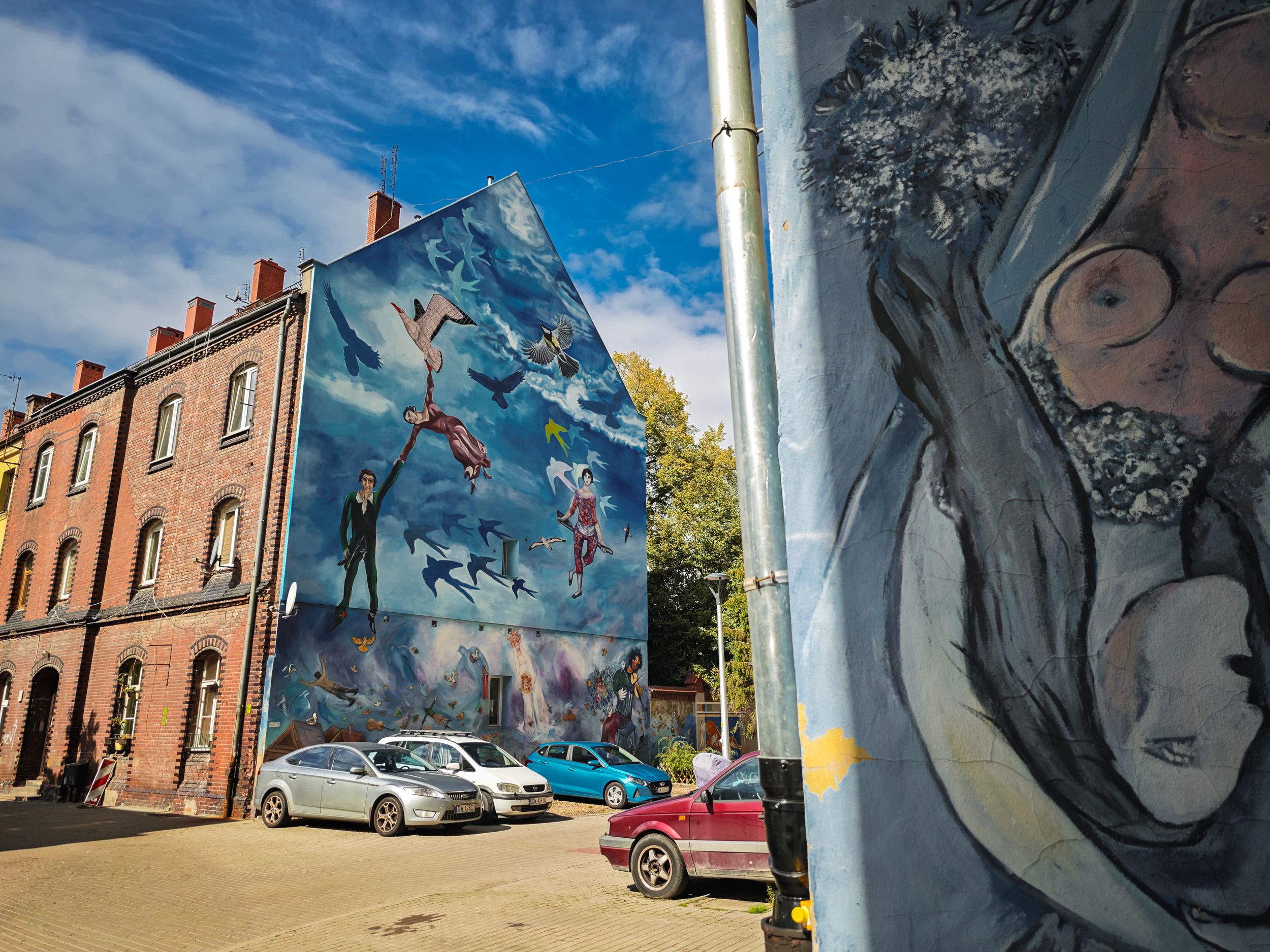 Nadorze Colourful Backyards with blue sky and vibrant street art mural in Wroclaw, urban photography Poland